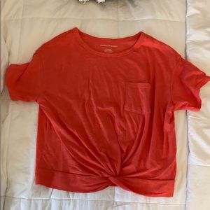 orange shirt with twist at bottom NWT